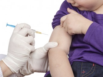 A doctor giving a child an injection